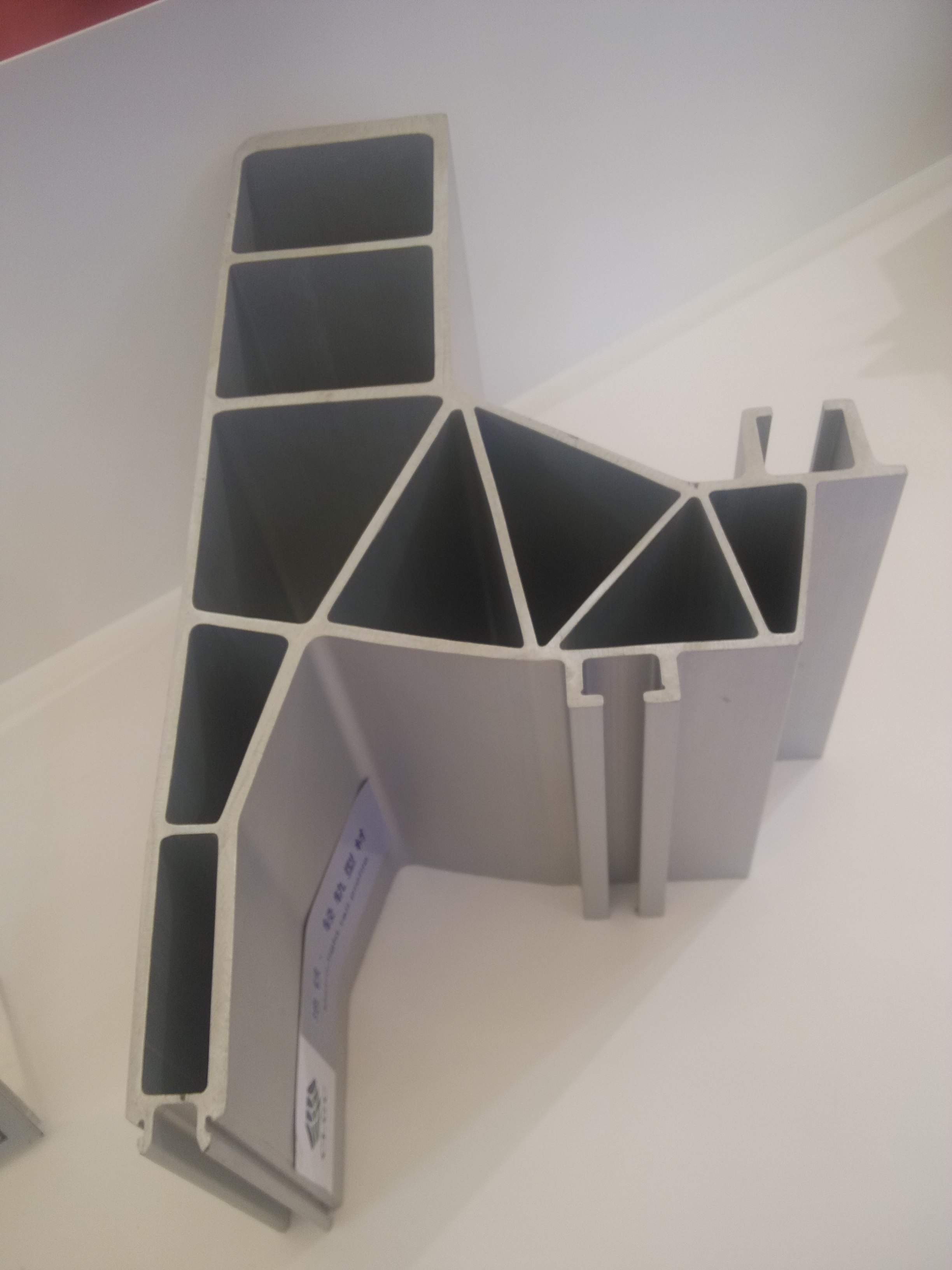 Close view of a complex hollow aluminum profile with several internal chambers