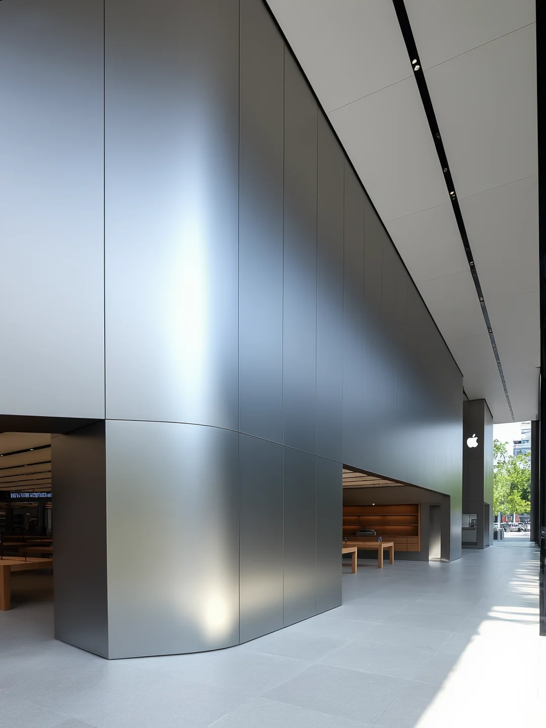 Curved metallic entrance cladding