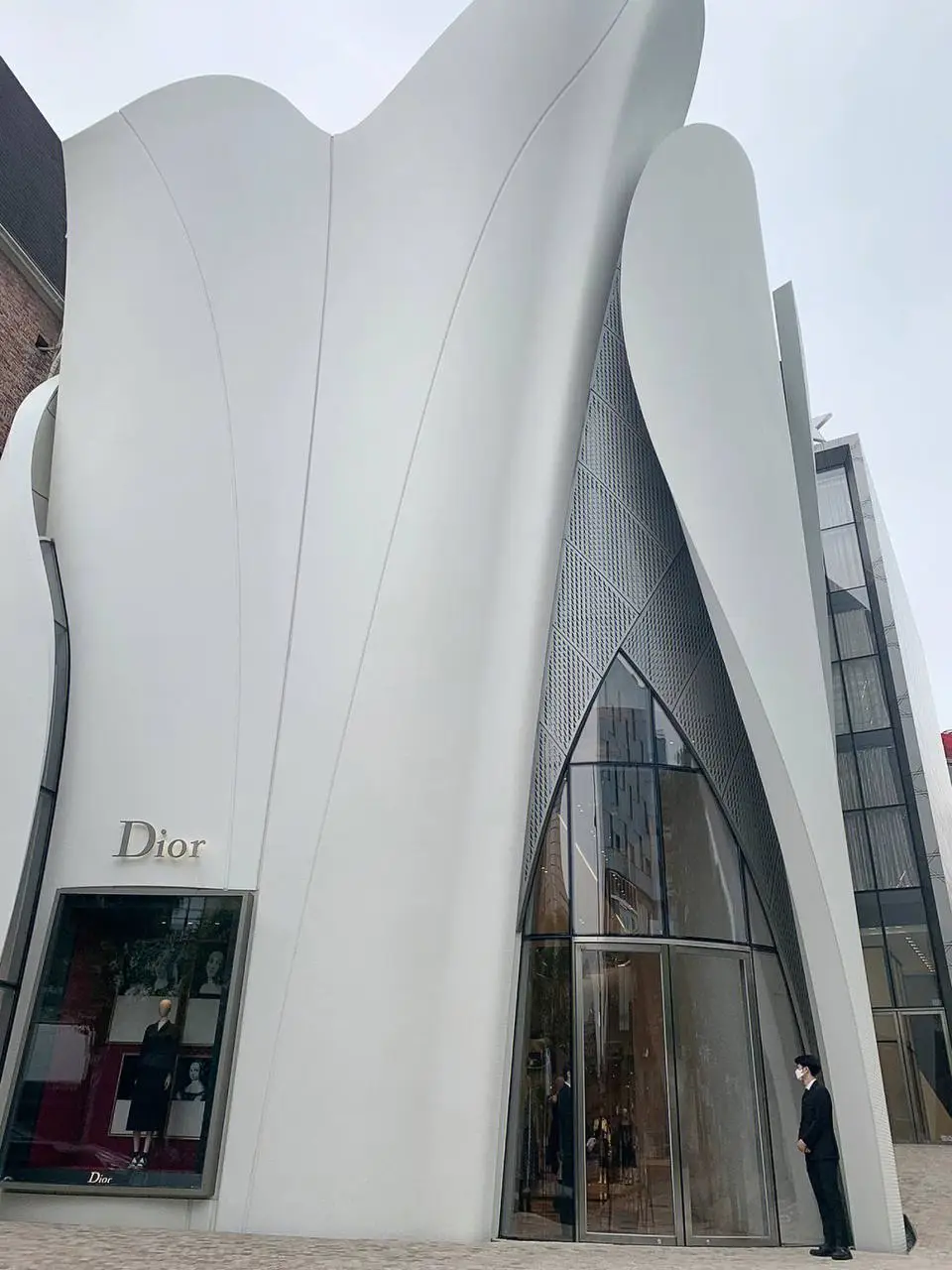 White sculptural facade with flowing curved wall forms